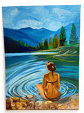 The Quiet Between Ripples: original painting by Celina Khoury of a woman sitting still in a mountain lake